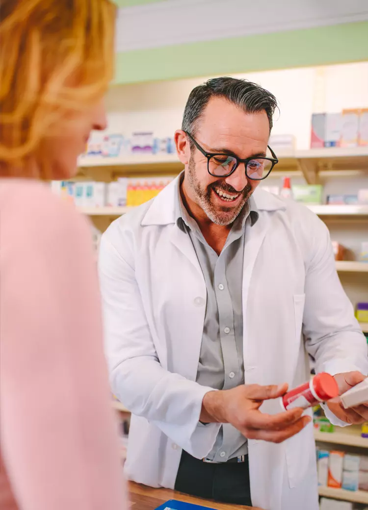 pharmacist showing customer medication