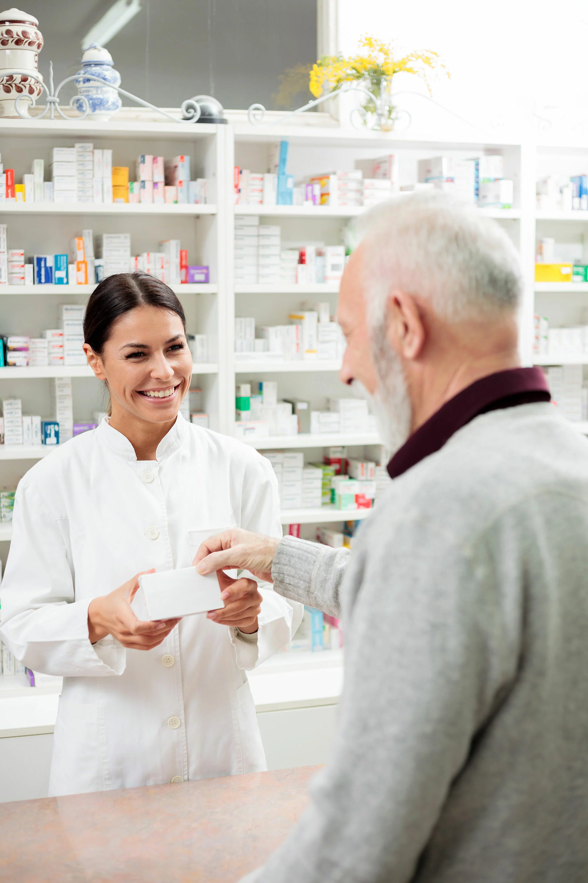pharmacist helping older male customer