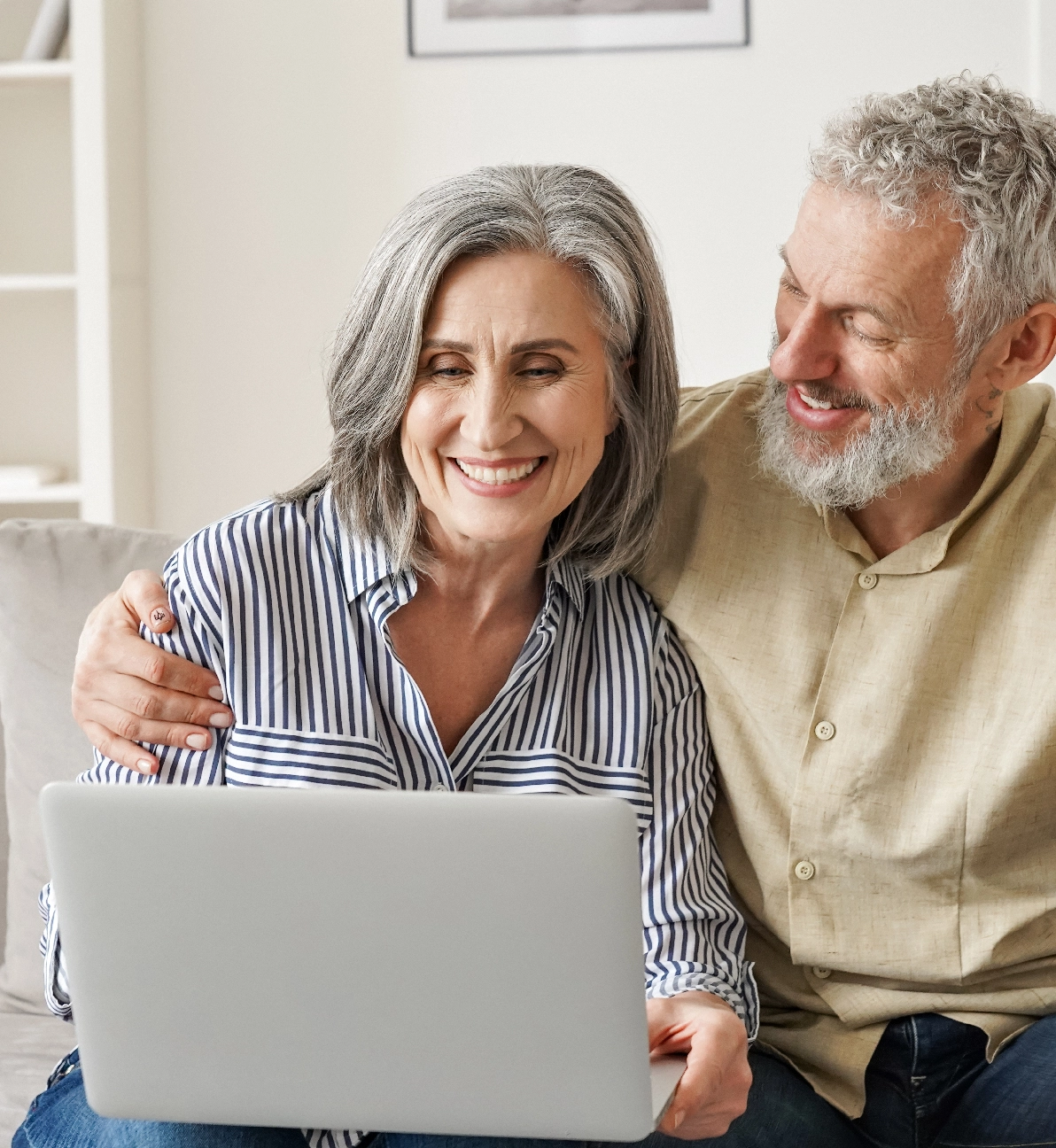 older man and woman looking at a laptop