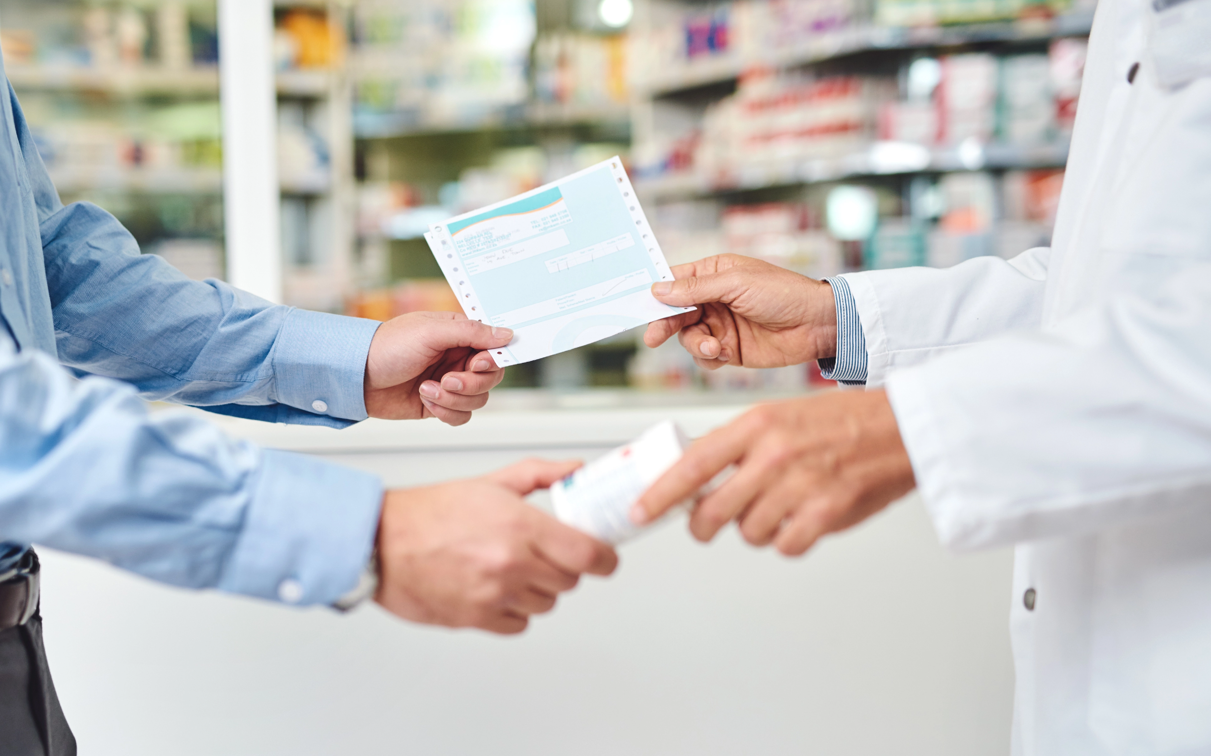 pharmacist giving customer prescription