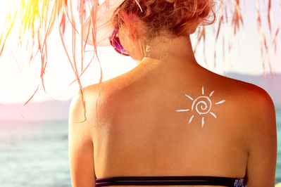woman with sunscreen drawing of the sun on her back