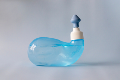 blue neti pot filled with saline solution